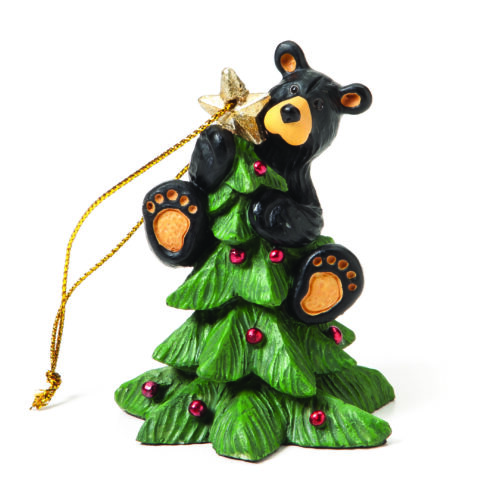 A black bear climbing a decorated Christmas tree ornament.