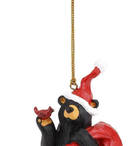 A festive black bear ornament with a Santa hat and red cape.