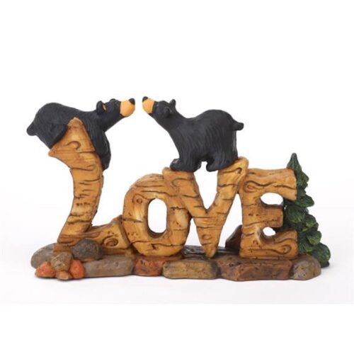 Wooden sculpture spelling 'LOVE' with two touching birds.