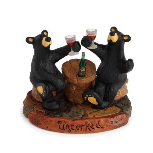 Two bears enjoying wine at a small table sculpture.