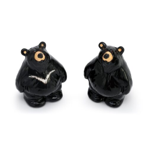 Two black bear-shaped salt and pepper shakers with cute expressions.