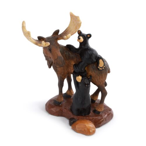 A small figurine of a moose carrying a person and a dog.