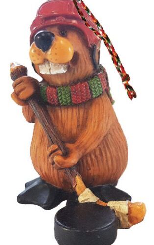 A wooden beaver figurine wearing a colorful scarf and holding a broom.