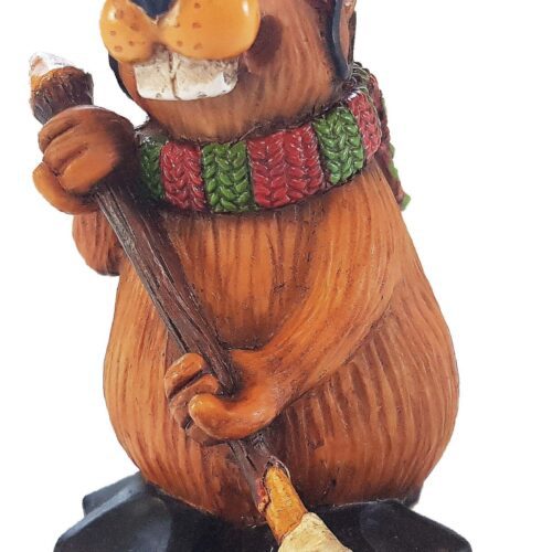 A wooden beaver figurine holding a broom and wearing a colorful scarf.