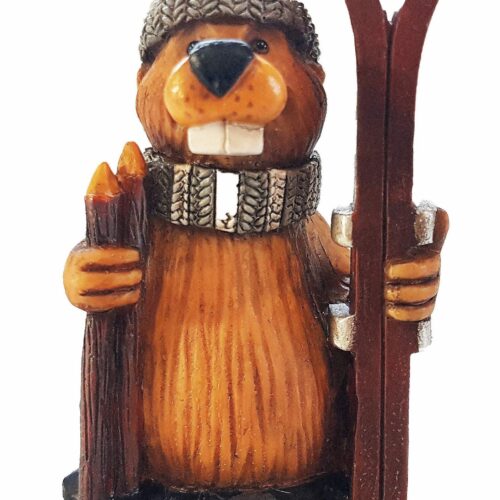 A wooden beaver figurine holding skis and ski poles.