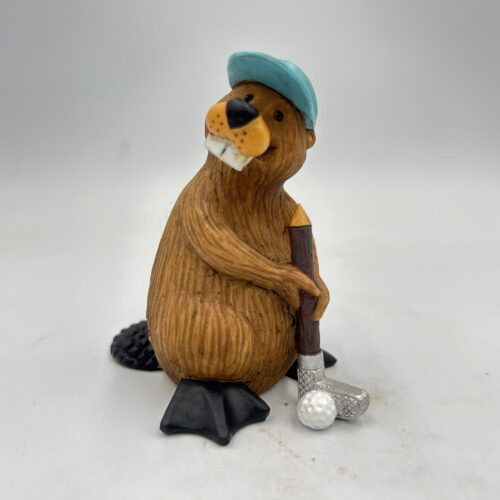 A beaver figurine wearing a blue hat and holding a golf club.