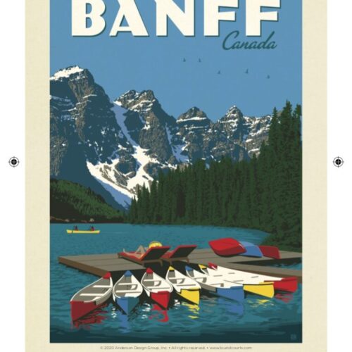 Colorful canoes docked by a serene mountain lake in Banff, Canada.