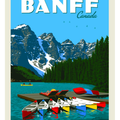 Colorful canoes docked on a pristine lake with snow-capped mountains in Banff, Canada.