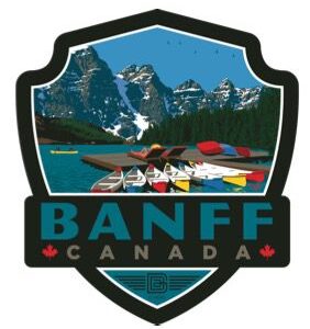 Colorful canoes on a lake with mountain backdrop in Banff, Canada.