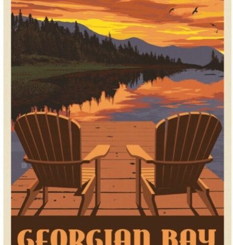 Two wooden chairs by a lake at sunset with mountains in the background.