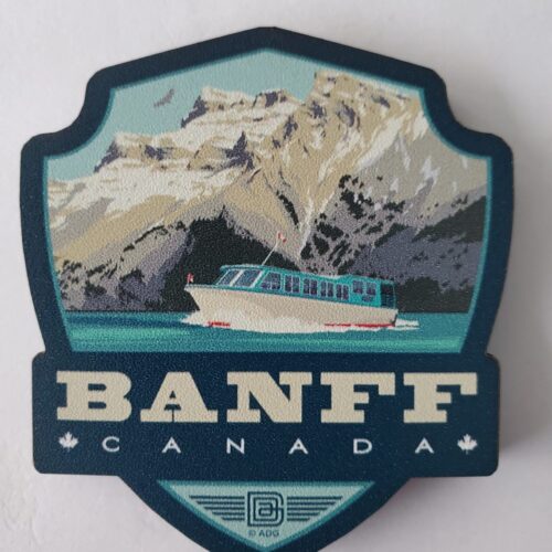 Scenic Banff, Canada emblem with a boat on turquoise waters and mountains.
