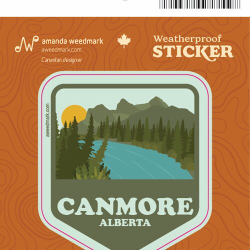 Weatherproof sticker of Canmore, Alberta with mountains and a lake.