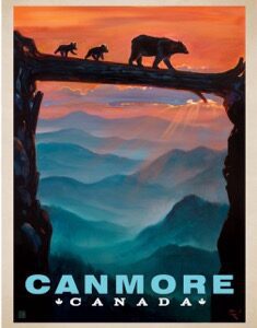 Silhouetted bears on a tree branch with a colorful mountainous sunset in Canmore.
