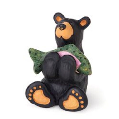 A playful black bear figurine holding a green fish.