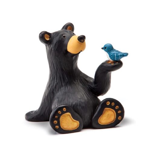 A cute black bear figurine holding a blue bird on its paw.