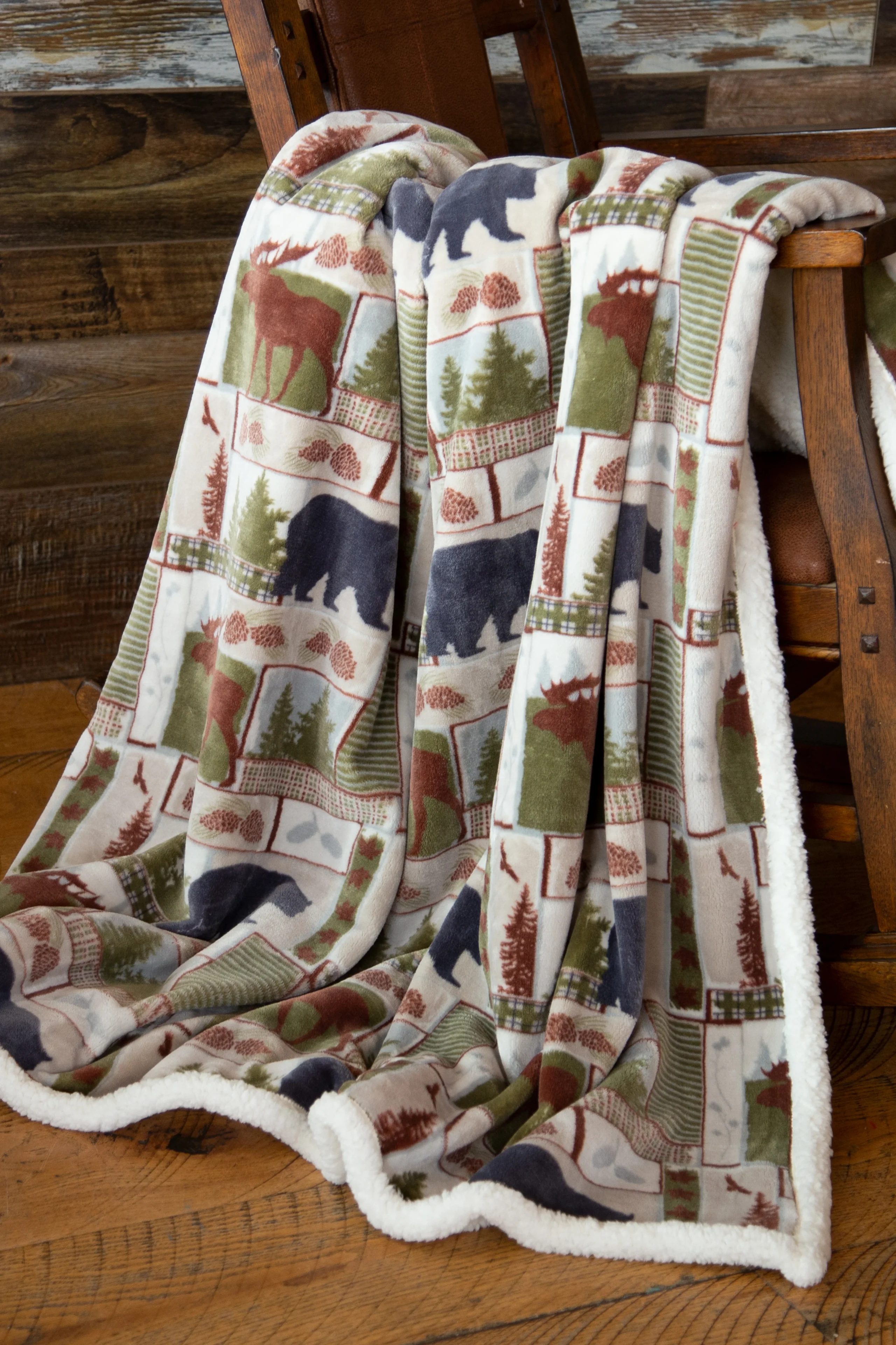 Cozy fleece blanket with bear and nature prints.