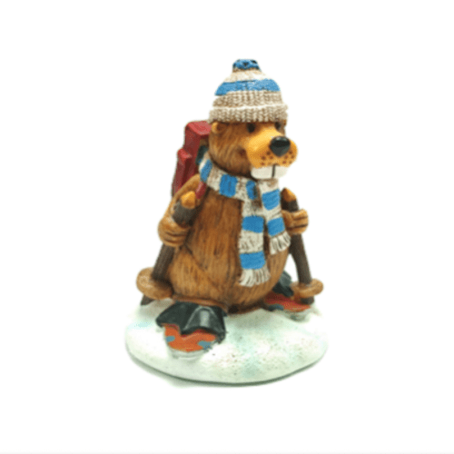 Skiing beaver figurine wearing blue hat and scarf